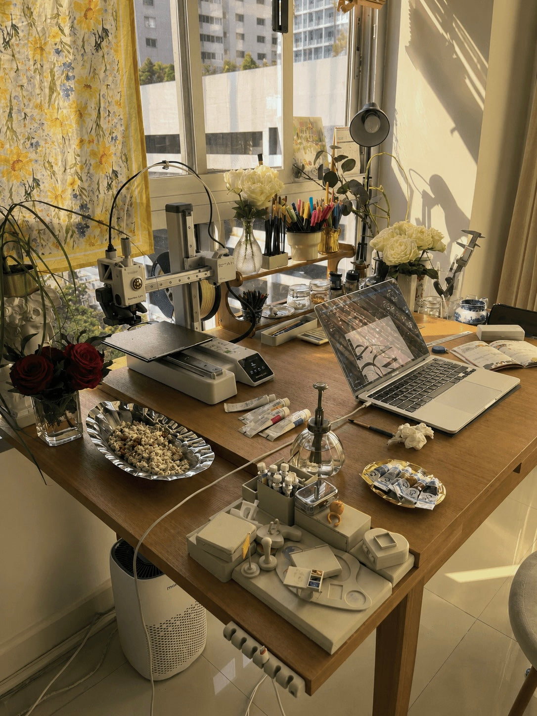 Studio desk with 3D printer and roses